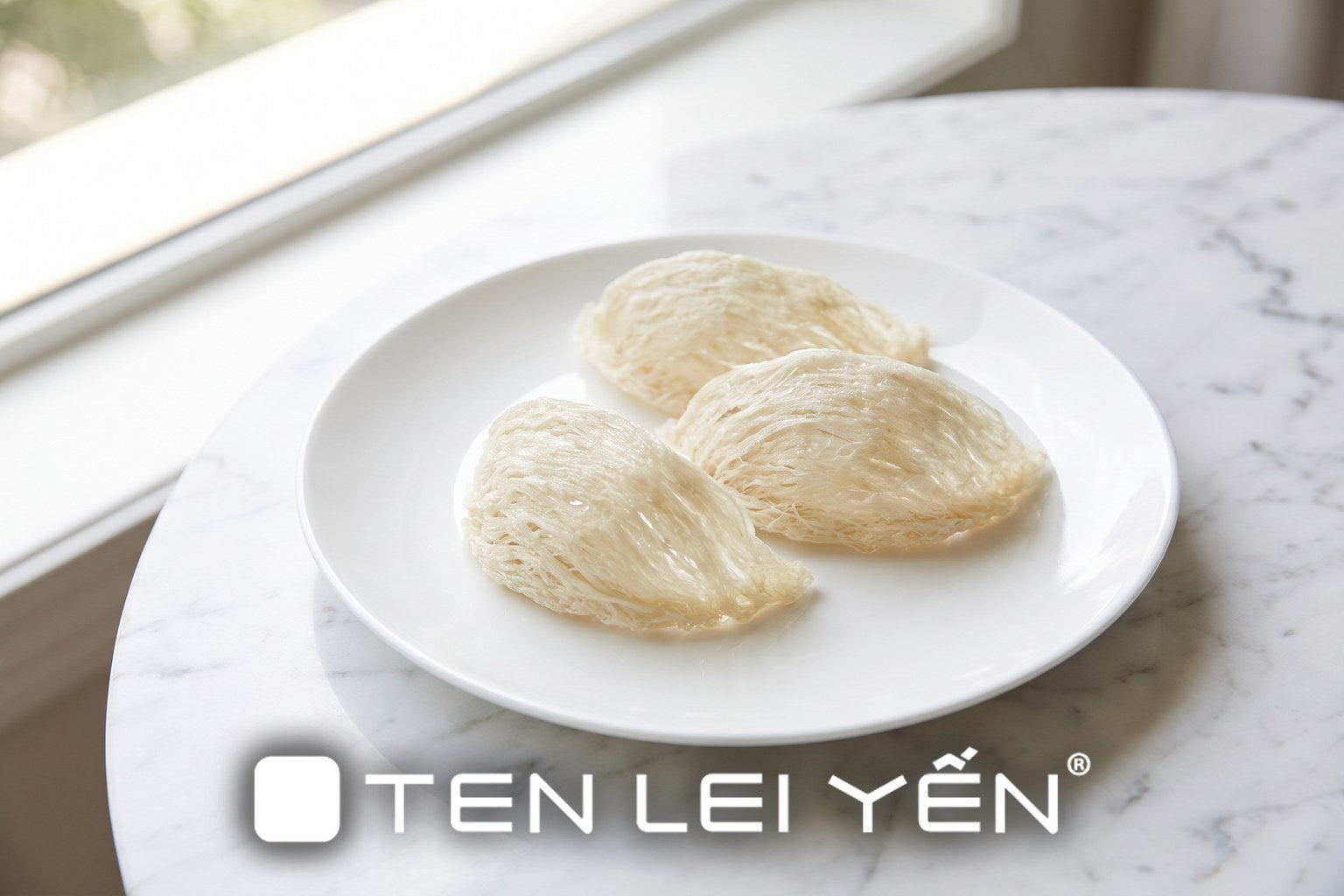 Fresh dried edible bird's nest pieces in a tight half-cup shape on a white plate