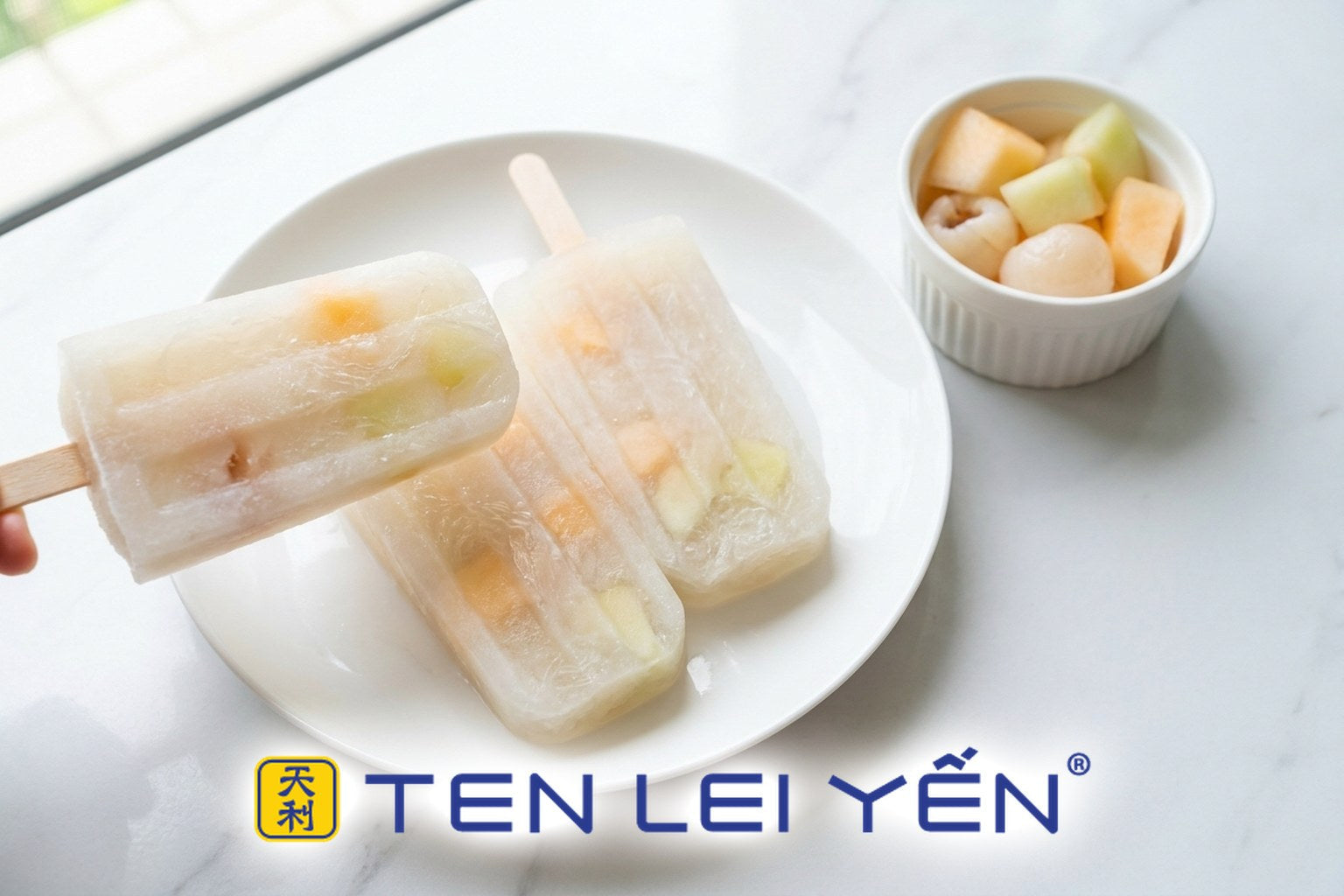 Homemade edible bird's nest ice pops with melon and lychee on a white porcelain plate