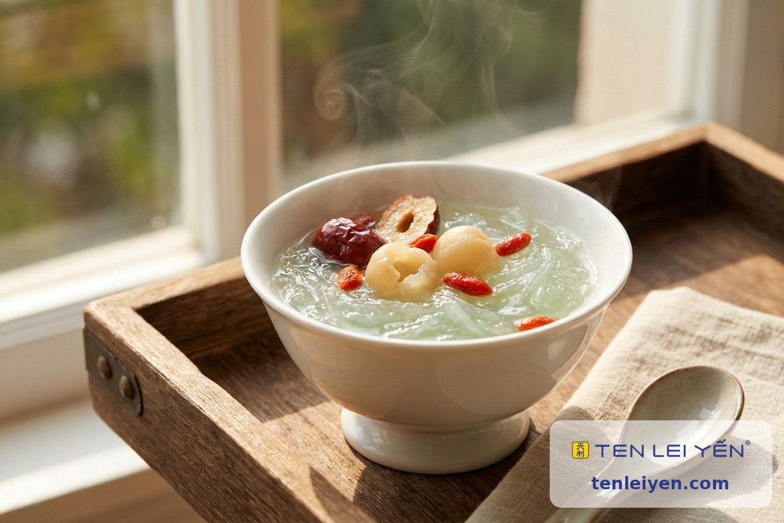 Warm bird's nest bowl with red dates, longan, and goji in a footed white porcelain bowl