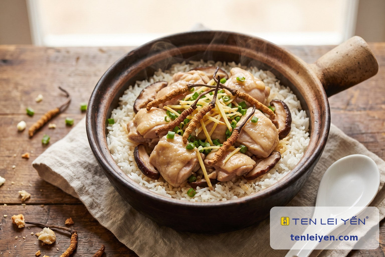 A clay pot of one-pot cordyceps chicken rice with whole wild cordyceps, shiitake, ginger and scallion