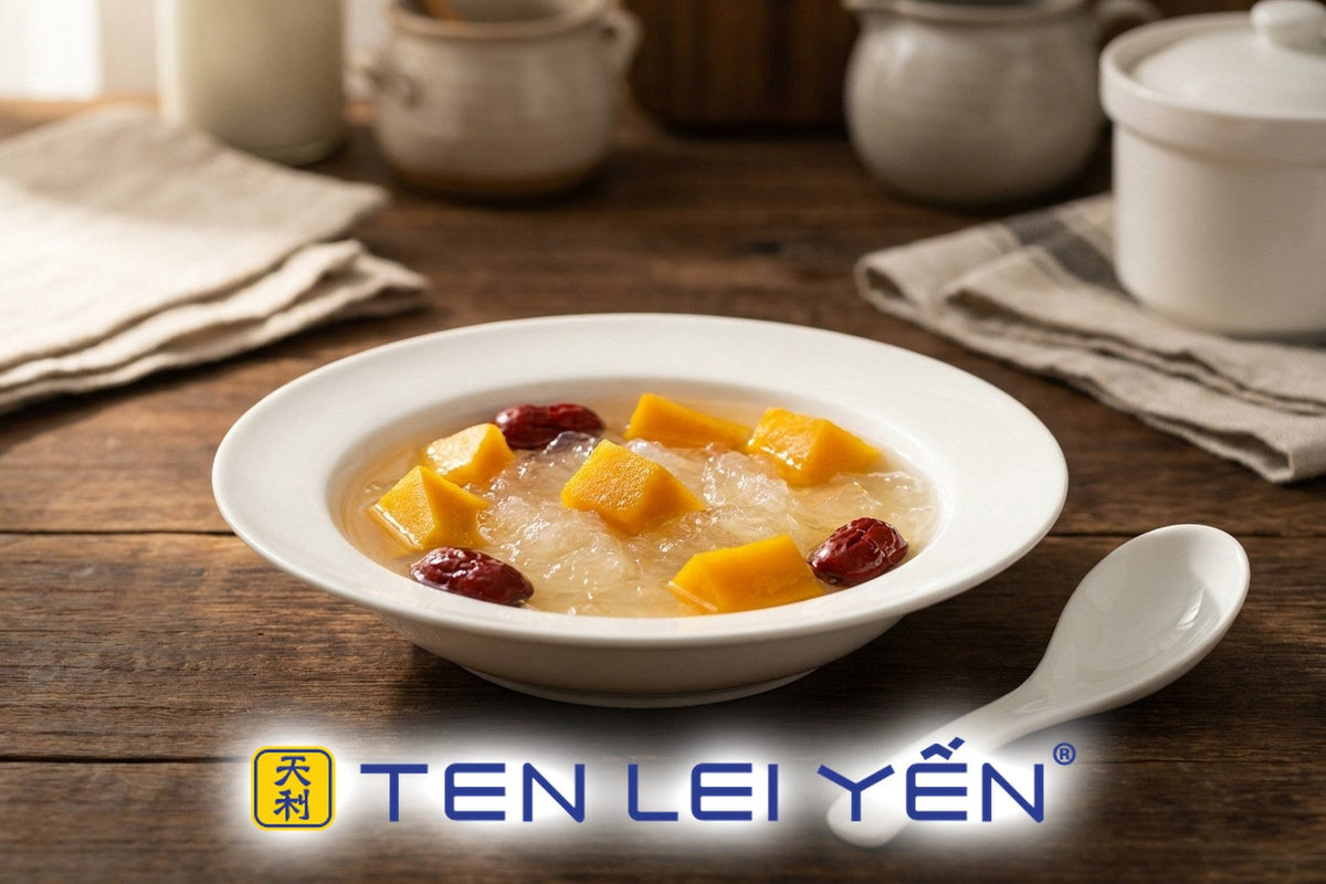 A white porcelain bowl of double-boiled bird's nest with kabocha pumpkin cubes and red dates