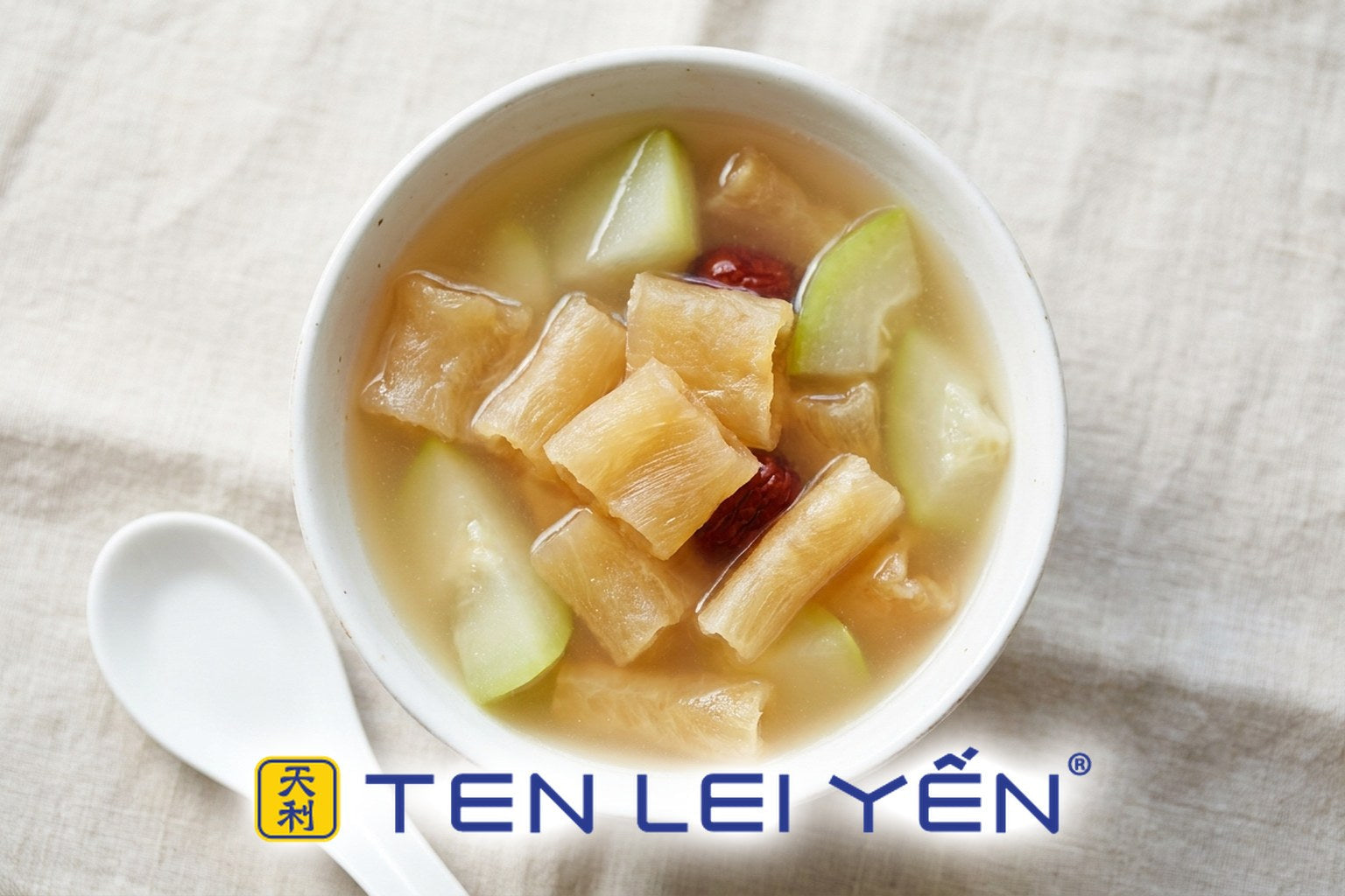 Bowl of fish maw and green papaya soup with clear pale gold broth in a white porcelain bowl