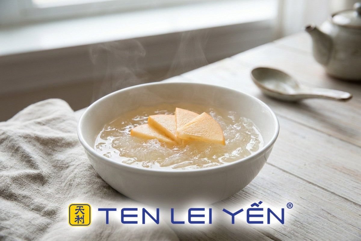 Warm double-boiled bird's nest with sliced Fuyu persimmon in a white porcelain bowl