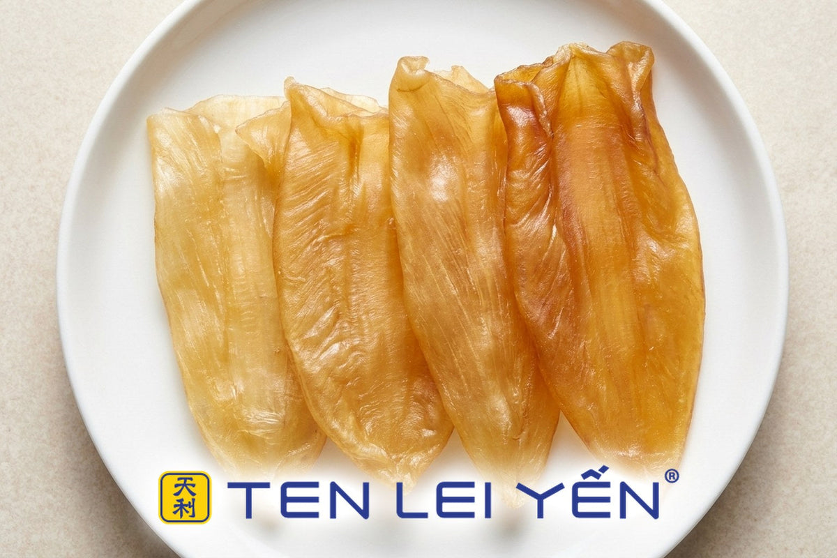 Dried fish maw pieces of varying thickness and color arranged on a white porcelain plate