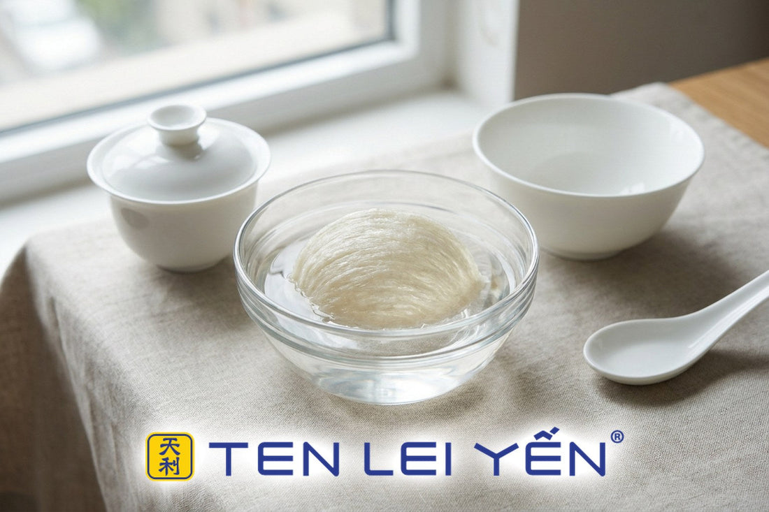 Bird's nest soaking in a clear glass bowl beside white porcelain bowls