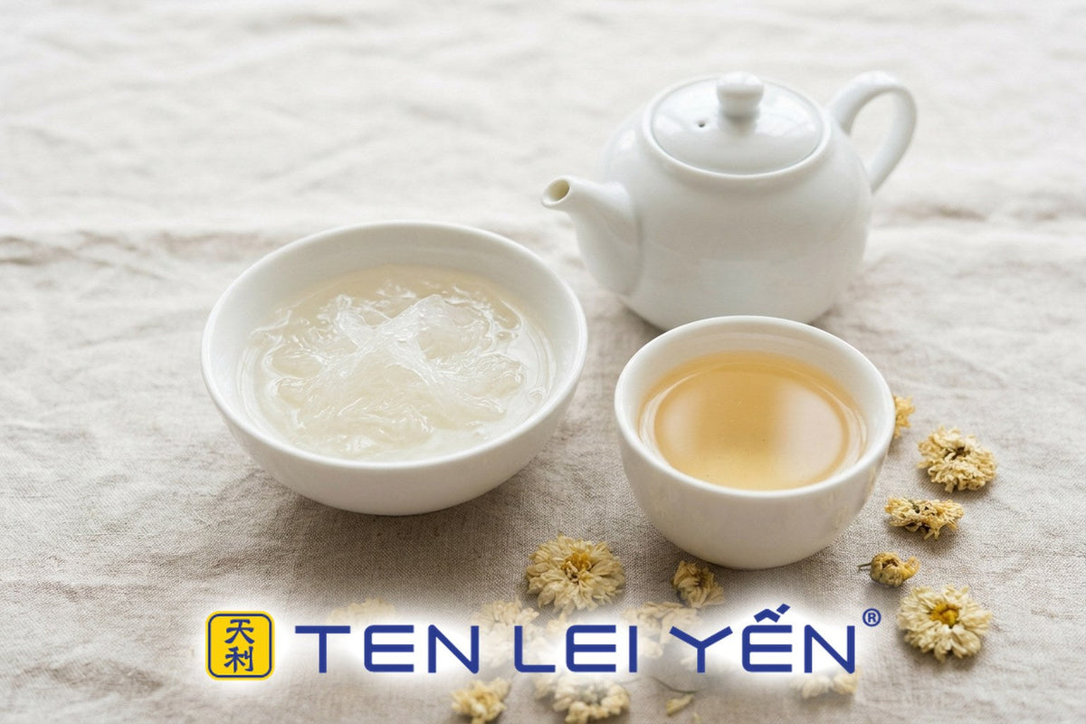 A bowl of bird's nest beside a cup of light oolong tea and dried chrysanthemum