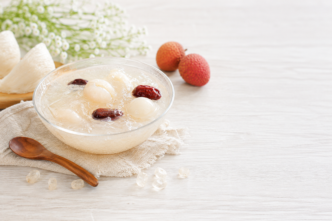 A bowl of prepared Ten Lei Yen edible bird's nest with lychee, longan, and red dates — a warm, traditional way to enjoy the delicacy