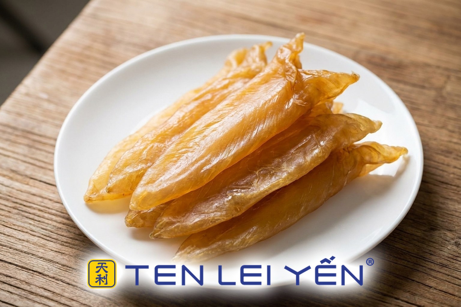 Golden-amber dried fish maw pieces on a white plate, showing their smooth surface and silky longitudinal grain