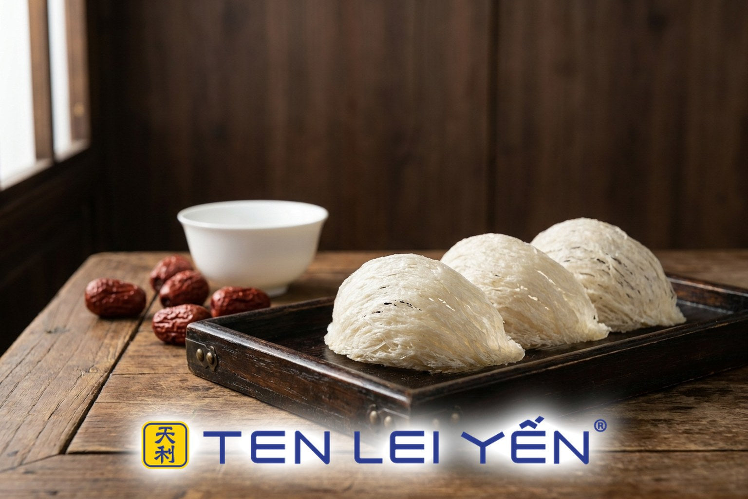 Three whole dried white edible bird's nests on a lacquered tray with red dates, evoking a heritage delicacy