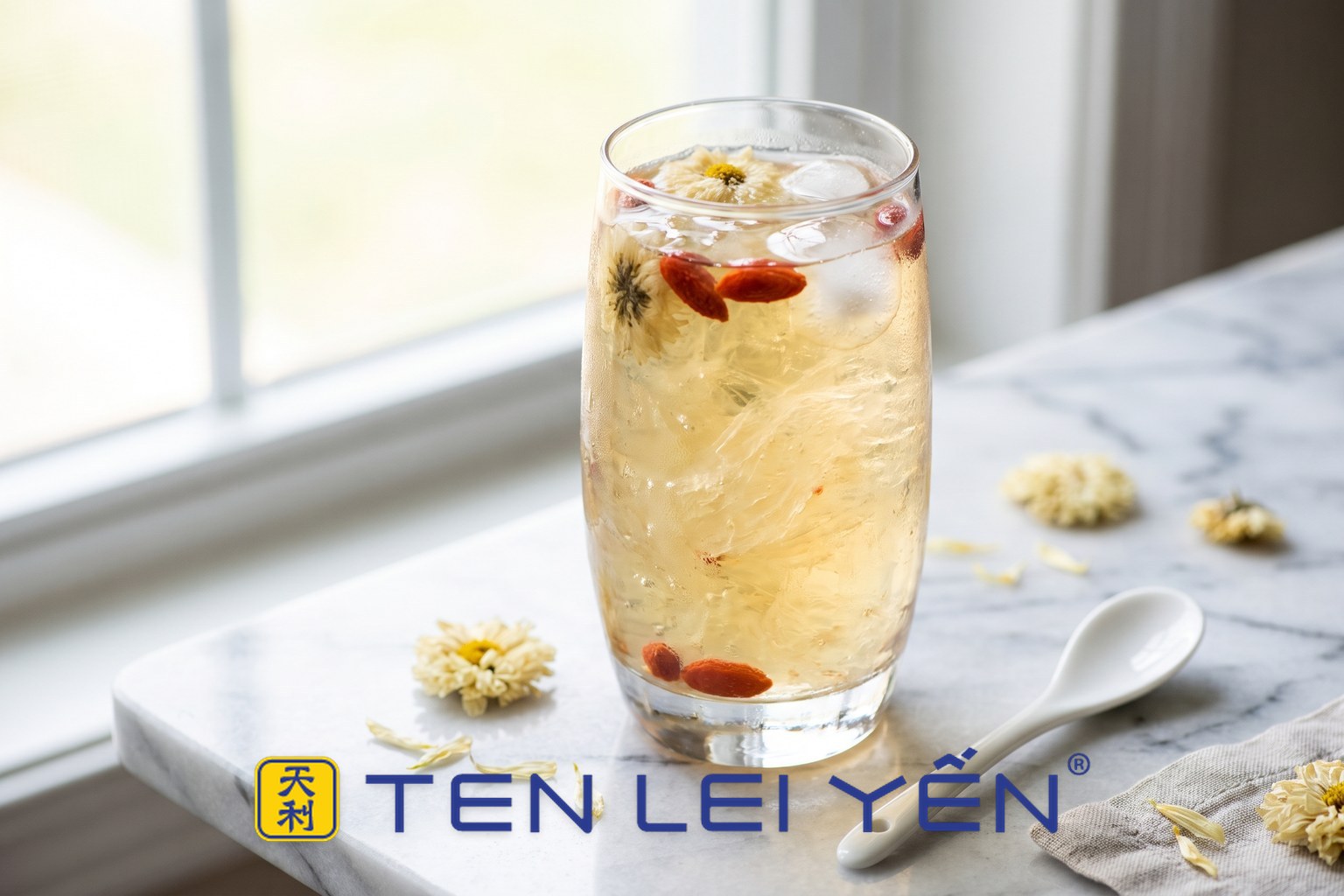Tall glass of chilled chrysanthemum and goji bird's nest drink with translucent nest strands and ice