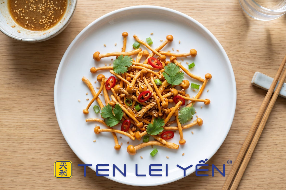 White plate of cold-dressed cordyceps militaris salad with sesame, cilantro, and red chili