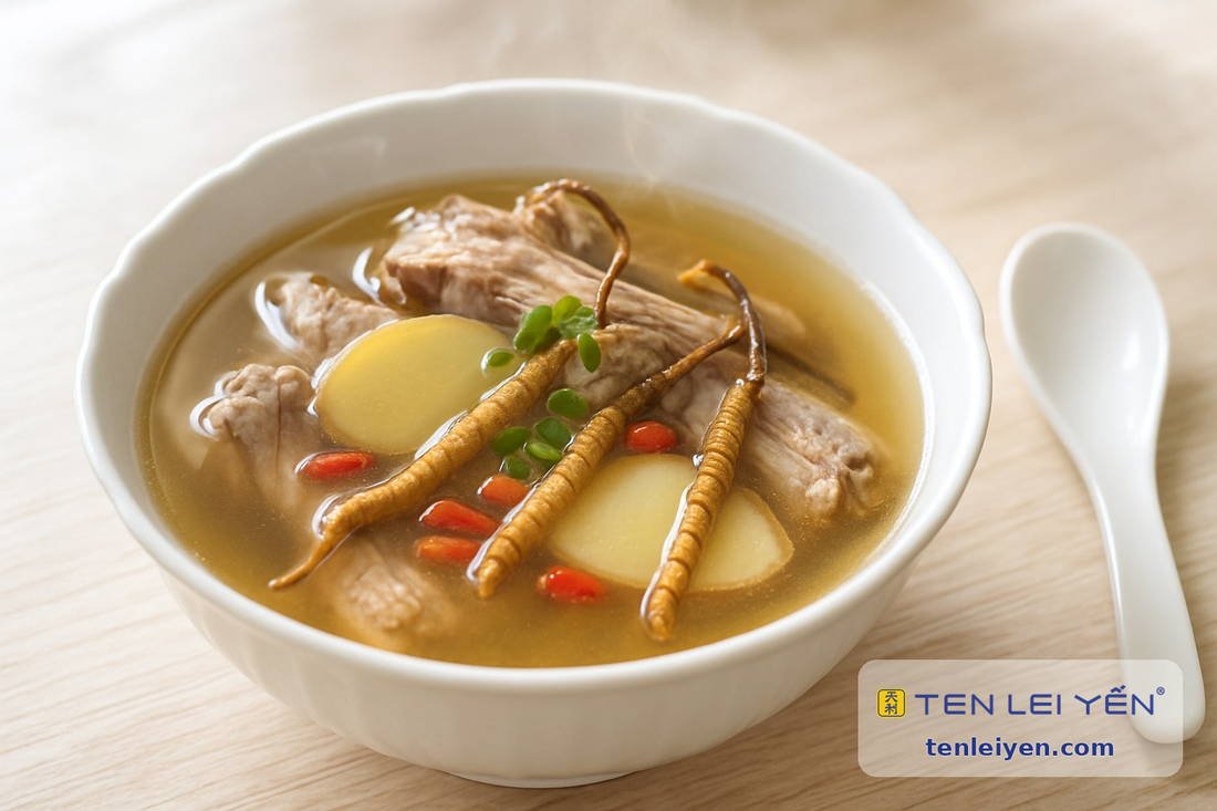 Double-boiled cordyceps duck soup with whole cordyceps, duck, ginger, and goji berries in a white bowl