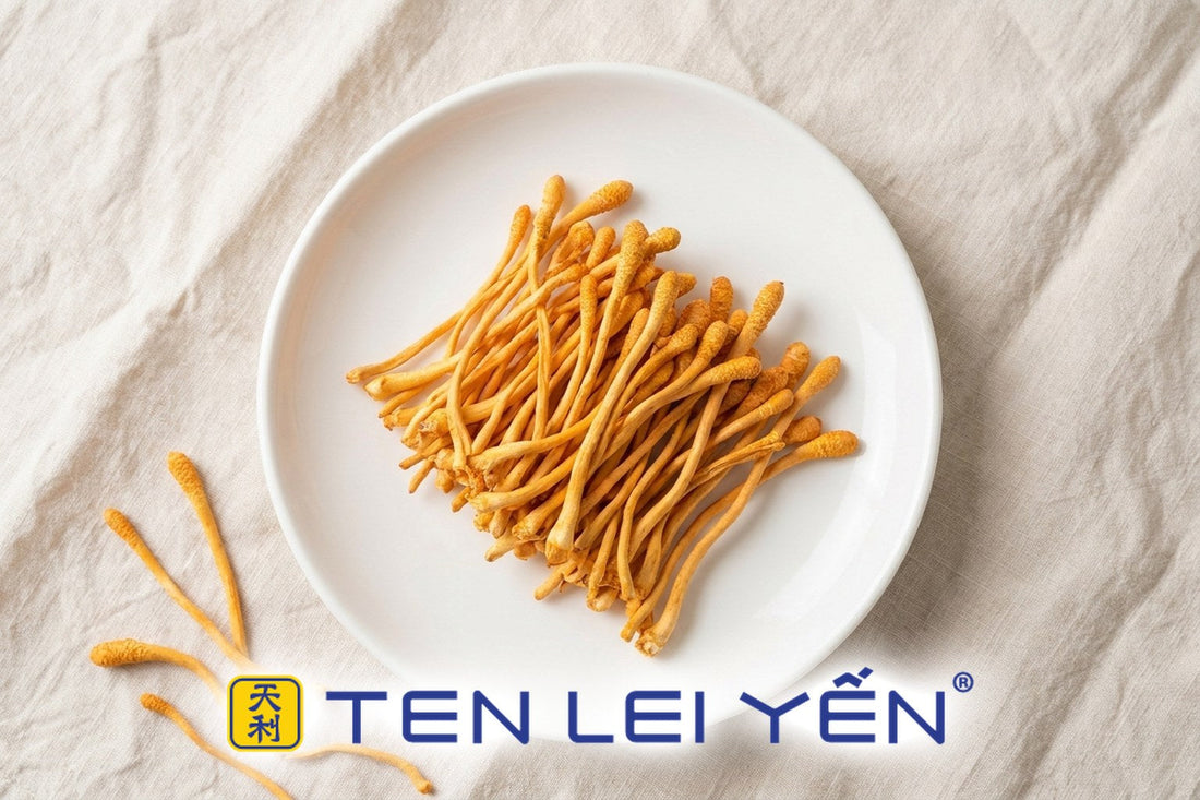 Premium dried cordyceps flower with bright golden-orange slender stalks on a white plate