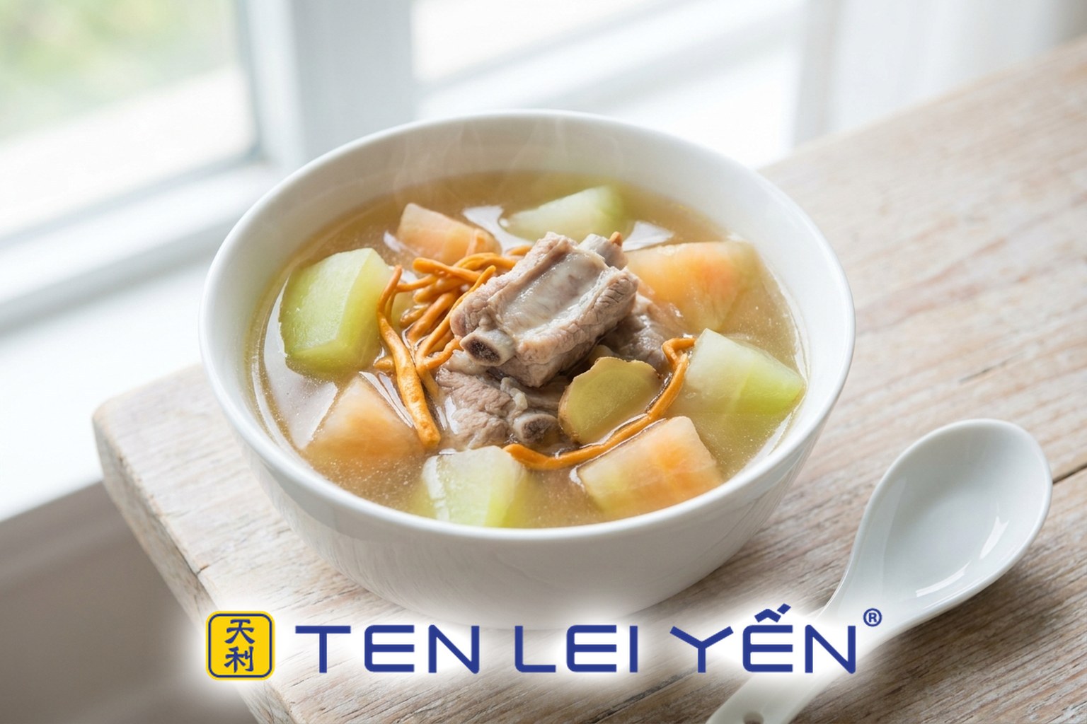 Clear green papaya and pork rib soup with cordyceps flower in a white porcelain bowl