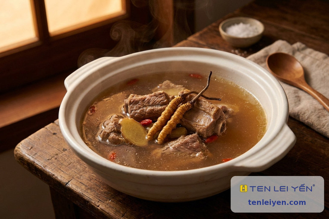 Rustic pot of pork-bone soup with two whole wild cordyceps, ginger, and goji berries