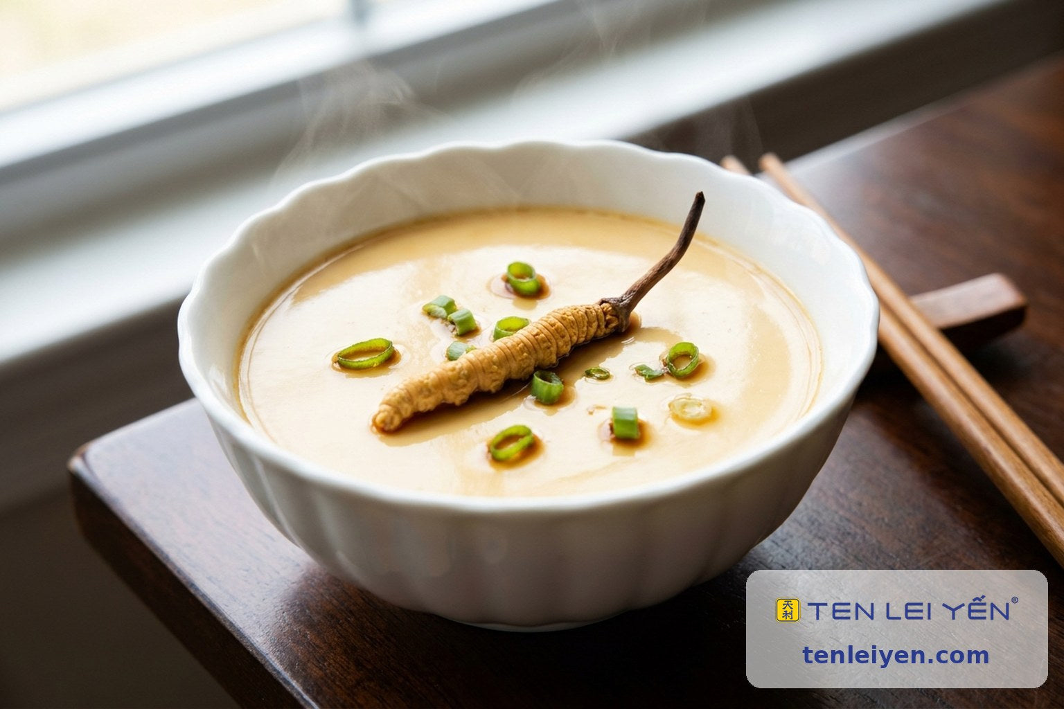 Silky steamed egg custard in a fluted white porcelain bowl with whole cordyceps and scallion