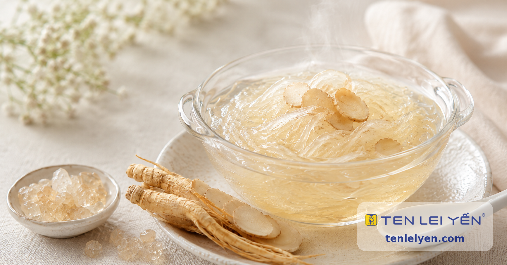 A glass bowl of Indonesian bird's nest dessert in clear broth, served with rock sugar and ginseng roots, with white flowers in the background