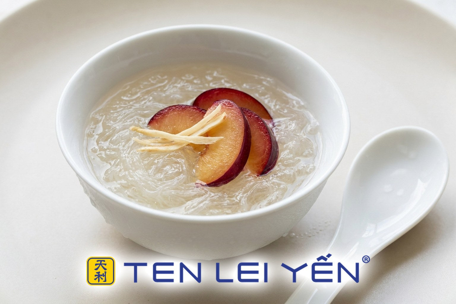 Chilled bird's nest with fresh red plum slices and thin ginseng slices in a white porcelain bowl