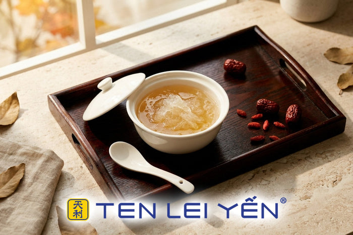Small lidded white porcelain bowl of cooked bird's nest with red dates on a lacquered tray, Hong Kong dessert-shop style serving