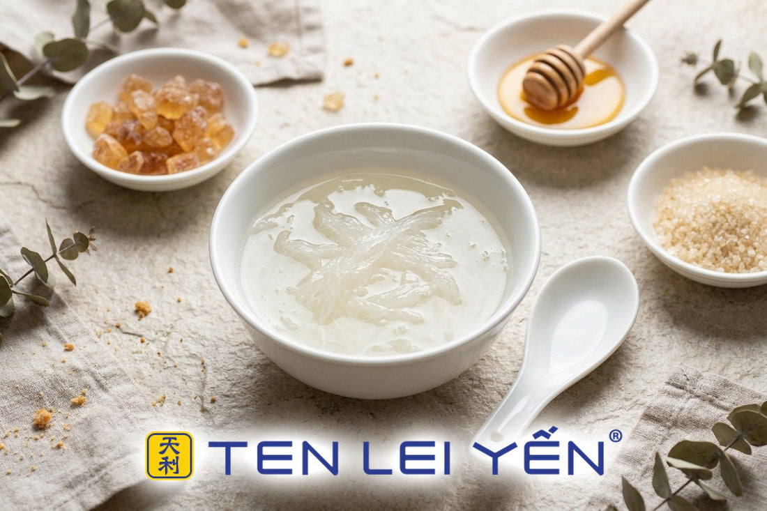 A bowl of double-boiled bird's nest on a white porcelain plate beside small dishes of rock sugar, honey, and monk fruit