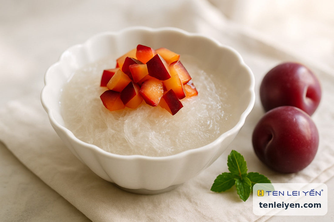Chilled bird's nest with fresh diced summer plums in a fluted white bowl