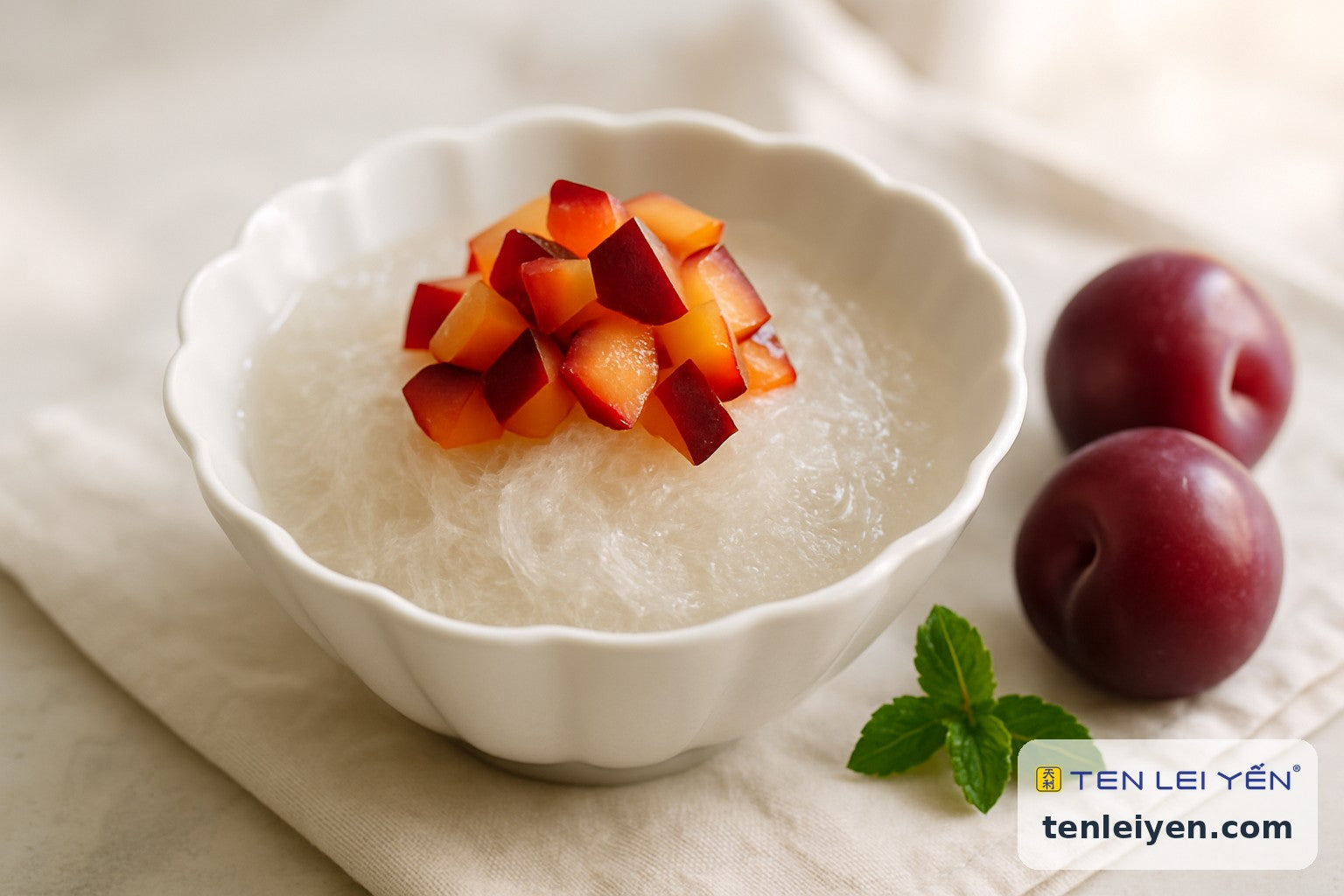 Chilled bird's nest with fresh diced summer plums in a fluted white bowl