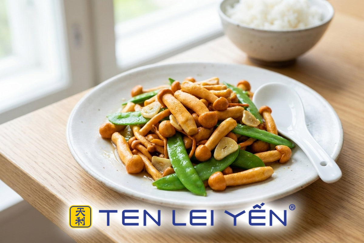 Stir-fried Cordyceps militaris orange clubs with snow peas and garlic on a white porcelain plate