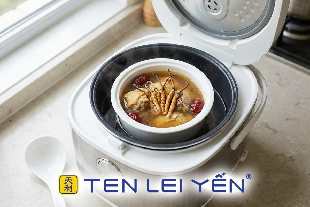 A ceramic double-boiler insert with wild cordyceps and chicken broth set inside a rice cooker