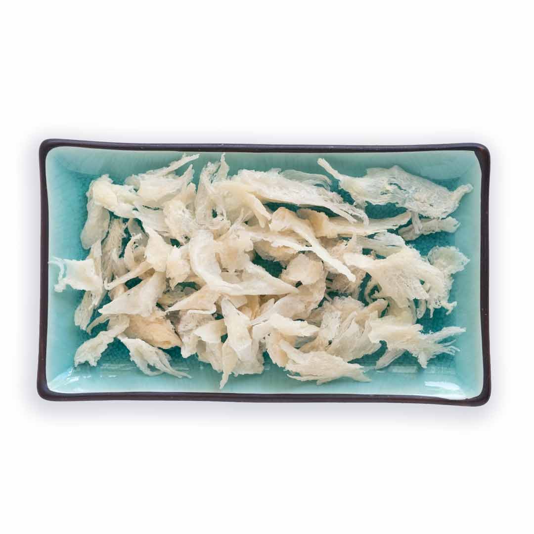 Samples of  white broken edible birds nest on a plate.